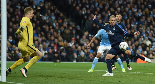 Manchester City's English goalkeeper Joe Hart (L) spreads himself wide to save a close-range shot from Real Madrid's Portuguese defender Pepe (R) during the UEFA Champions League semi-final first leg football match between Manchester City and Real Madrid at the Etihad Stadium in Manchester, northwest England, on April 26, 2016.