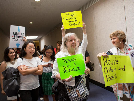 Protesters walk out of a hearing room after disrupting a Senate Judiciary Committee hearing entitled "Oversight of Immigration Enforcement and Family Reunification Efforts" on Capitol Hill in Washington, US, July 31, 2018. /REUTERS