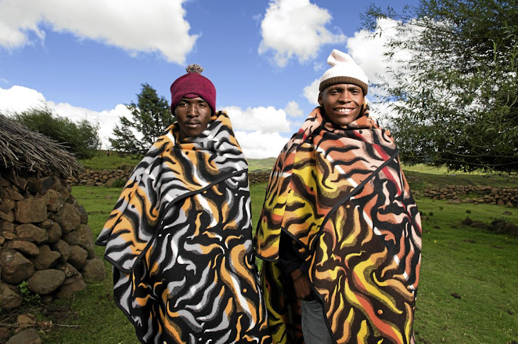 Two men who went for the Malakabe (flame) design. The blankets worn by Basotho are moving with the times, and are promoted to young people through the royal fashion fair ever year in Lesotho.