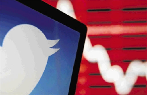 NOT SO CHIRPY: The Twitter logo on an LCD screen in front of a displayed graphPhoto: Dado Ruvic/Reuters