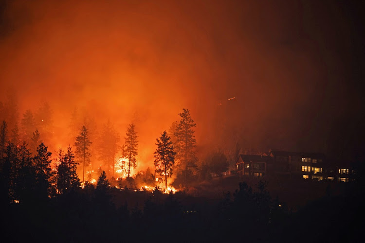The McDougall Creek wildfire burns next to houses in the Okanagan community of West Kelowna, British Columbia, Canada, August 19 2023. Picture: CHRIS HELGREN/REUTERS