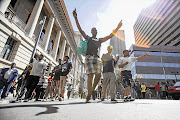 Members of the SA Transport and Allied Workers' union make their way out of Beyers Naude Square, Johannesburg, yesterday while their leaders negotiate with employers Picture: NKULULEKO MARAIS