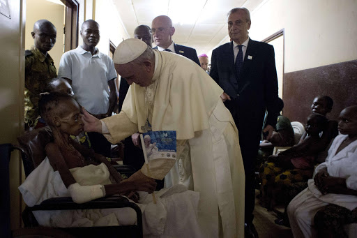 In this handout picture released by the Vatican press office Pope Francis visits a pediatric hospital in Bangui on November 29, 2015 as part of his trip to Africa. AFP PHOTO / OSSERVATORE ROMANO