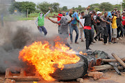 Protesters erected a burning barricade during protests on a road leading to Harare, Zimbabwe, on January 15 2019.