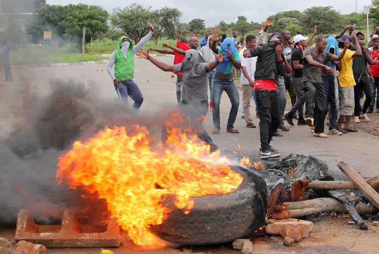 Protesters erect burning barricades outside Harare on January 15 2019. Citizens are feeling the bite of huge fuel price increases, a scarcity of fuel, tripling food prices and violent protests.