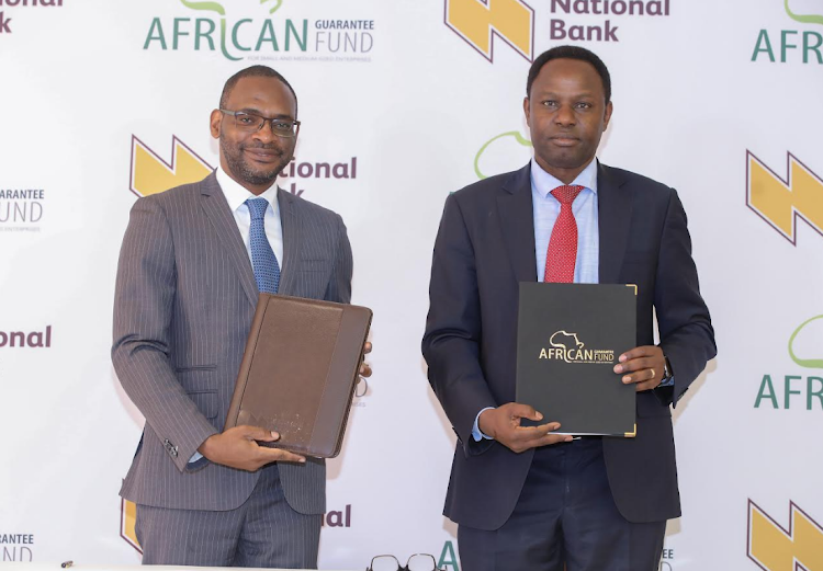 African Guarantee Fund Group CEO Jules Ngankam with National Bank of Kenya acting MD Peter Kioko during the signing of an agreement to support SMEs, in Nairobi, on November 8/HANDOUT