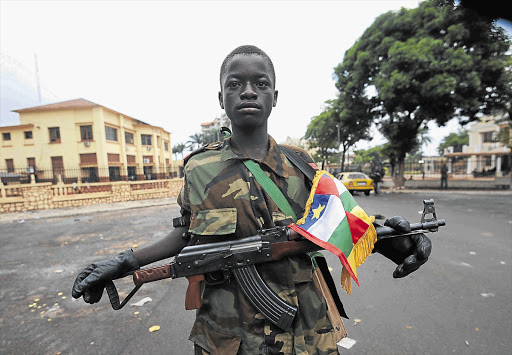 A young Seleka coalition rebel poses near the presidential palace in Bangui this week. Seleka coalition rebels seized the capital Bangui after the collapse of a two-month-old peace deal with Bozize's regime