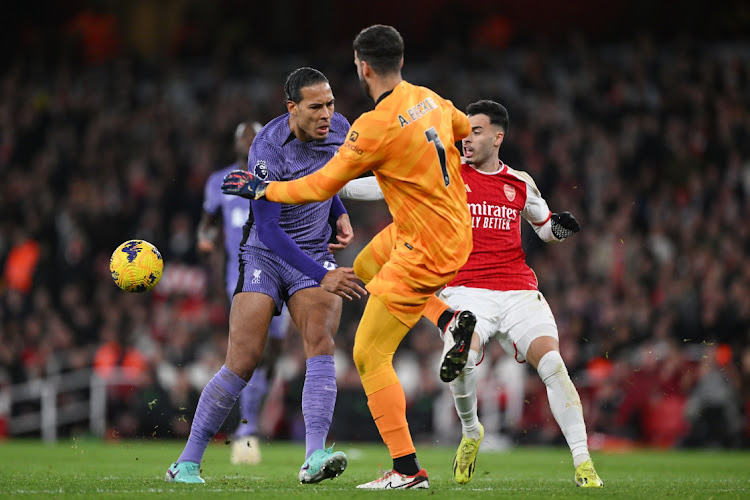 A defensive error from defender Virgil van Dijk and goalkeeper Alisson Becker of Liverpool leads to Gabriel Martinelli of taking a shot and scoring his Arsenal's second goal in their Premier League match at Emirates Stadium in London on Sunday.
