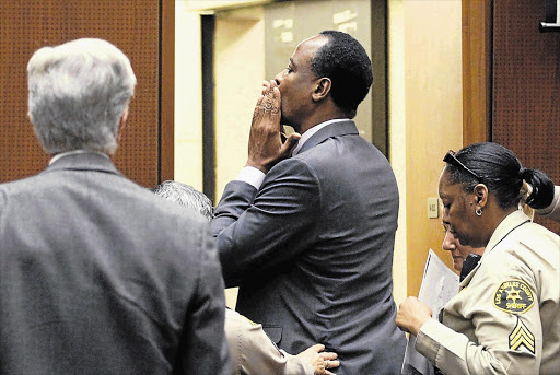 Dr Conrad Murray blows a kiss to an unidentified member of the Los Angeles courtroom audience after he was sentenced to four years in county jail for his involuntary manslaughter conviction of pop star Michael Jackson in 2009