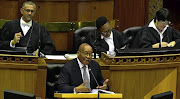 TICK TOCK: President Jacob Zuma replies to oral questions from opposition MPs in the National Assembly yesterday.