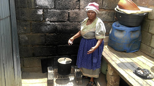 Emily Letlhaka, 78, of Mapetla has gone back to old ways of living as Eskom won't fix a damaged transformer. /PENWELL DLAMINI