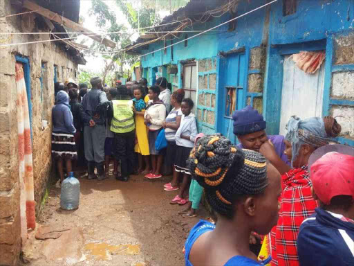 Neighbours outside the Roysambu house of Ann Gathoni, who was killed alongside her three children, on May 7, 2018. /MAUREEN KINYANJUI