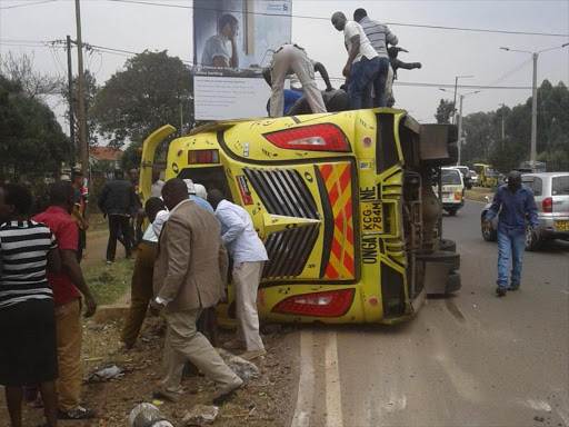 Passers-by rescue people from the vehicle that was involved in an accident on Lang'ata road in Nairobi, Sunday, September 25. /COURTESY