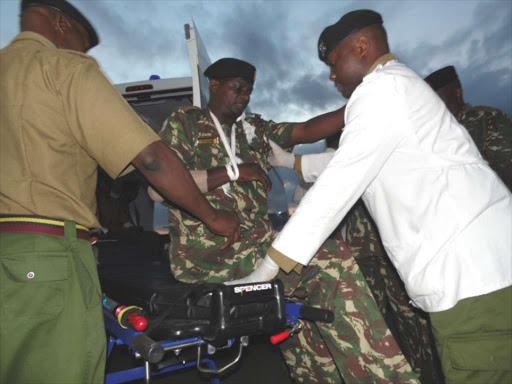 Siaya County AP commander Chrispus Mutali is helped into an ambulance at Wilson Airport after arriving from Kisumu./FILE