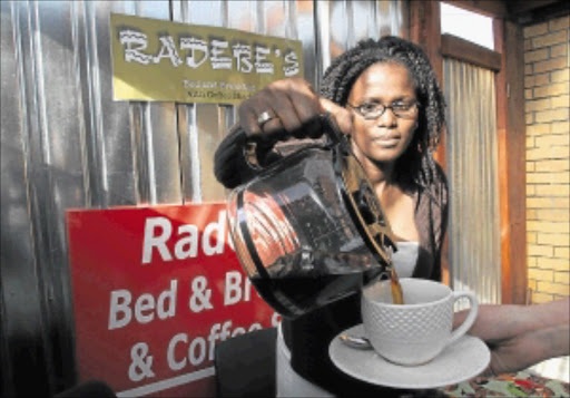 HOME BREW: Minah Radebe pours out her passion and a cup of coffee after lunch at her B&B and Coffee Shack, situated in the heart of Langa, Cape Town. Photo: MARK WESSELS