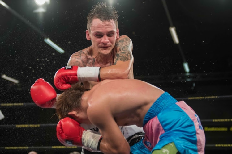 Hekkie Butler from South Africa Joey punches Canoy from Philippines during vacant IBO Light Flyweight title bout between Hekkie Budler and Joey Canoy at Emperors Palace on February 04, 2017 in Johannesburg, South Africa.
