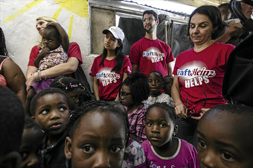 START RIGHT: Children wait yesterday as employees of food company Kraft Heinz distribute meals at two creches in Vrygrond, Cape Town, as part of the company's commitment to the Rise Against Hunger campaign.