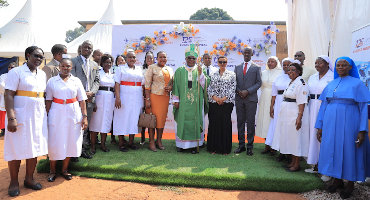 Archbishop Paul Semwoger, Vice chairperson Board of governors Naiga Caroline Katongole[L],Minister Hanifa Kawooya Bangirana, hospital Executive Director Dr. Julius Luyimbazi and staff of Lubaga hospital pose for a group photo