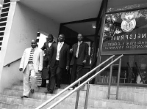 SUPPORT: Lawyer Gezani Maluleke (in a case), Ernest Khoza, far right, his brothers Lucky Rikhotso and Fumani Khoza.20/01/2009. © Sowetan. Pic. Riot Hlatshwayo