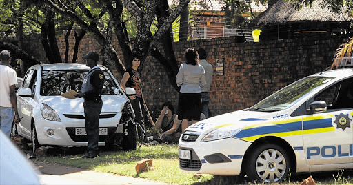 Family members at the roadside where Chanelle Henning's body was lying after she was shot in Pretoria. File photo.