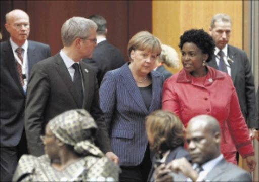 German Environment Minister Norbert Roettgen, German Chancellor Angela Merkel and International Relations and Co-operation Minister Maite Nkoana-Mashabane at the Petersberg Climate Dialogue in Berlin yesterday. They were preparing for the UN climate conference in Durban in November Picture: REUTERS