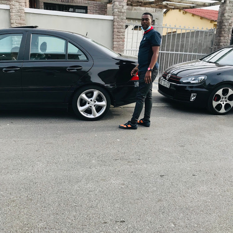 Lwazi Landzela with his father's Mercedes Benz and VW Polo which were allegedly used by the kidnapping syndicate he is allegedly a member of. Both cars have been seized by the police.