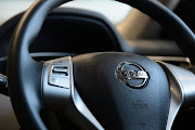 The Nissan Motor Co. badge is displayed on the steering wheel of a vehicle at the company's showroom in Yokohama, Kanagawa Prefecture, Japan, on Wednesday, May 13, 2015. Nissan plans to build more than 1 million vehicles in Japan next year for the first time since 2013, as the weaker yen boosts earnings from exports. Photographer: Akio Kon/Bloomberg