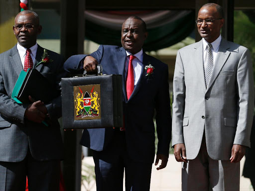 Cabinet Secretary Henry Rotich (C) with PS Kamau ugge (L) and Central Bank of Kenya Governor Patrick Njoroge leave National Treasury building for Parliament to present the 2016-17 budget on June 8, 2016 /JACK OWUOR