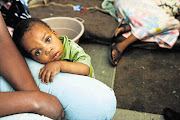 One-year-old Mike clings to his mother, Leya Babushi, in the small room they share with other foreign nationals at the Central Methodist Church in Johannesburg. Few of them are expecting any presents for Christmas. File photo