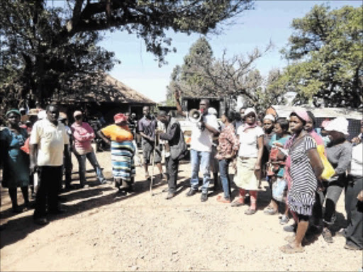 WITCH-HUNT: Earlier this week the man holding a stick and his wife were accused by Mukumbani villagers of being responsible for the disappearance of another villager, who was found yesterday Photo: Suprise Mazibila
