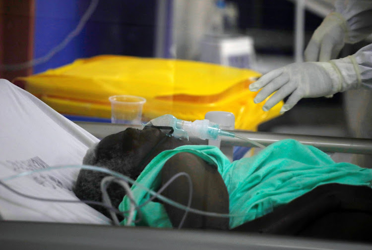 A member of the medical staff treats a coronavirus disease patient inside the Covid-19 ICU of Machakos Level 5 Hospital, Machakos, on October 28, 2020