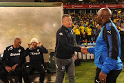 Mamelodi Sundowns' head coach Pitso Mosimane (R) shakes hands with his Bidvest Wits counterpart Gavin Hunt (L) during the Absa Premiership match at Loftus Versfeld Stadium on April 14, 2018 in Pretoria, South Africa. 
