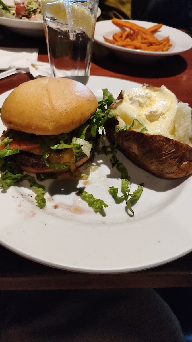 Gluten free cheeseburger with baked potato.