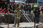 Rescue workers continued to scour the rubble of the collapsed building in Victoria Street on Wednesday, trying to recover workers presumed trapped in the debris. About 75 construction workers were on site when the building collapsed at about 2pm on Monday. 