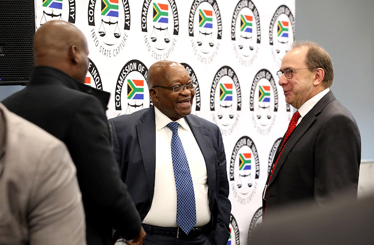 Former president Jacob Zuma shares a light moment with evidence leader Paul Pretorius during a tea break at the state capture inquiry where he continues to give testimony on Tuesday.