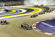 LEADER OF THE PACK: British Formula One driver Lewis Hamilton, centre, of Mercedes survived a heart-stopping moment towards the end of the race to win the Singapore Grand Prix yesterday