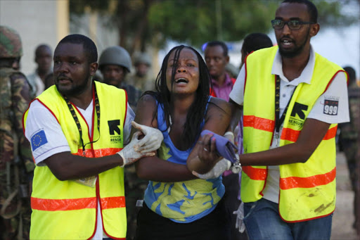 A woman reacts as she is rescued out of the building where she had been held hostage as Kenyan soldiers entered the university building after a fierce fights with attackers at the Garissa University in Garissa town. EPA/DAI KUROKAWA