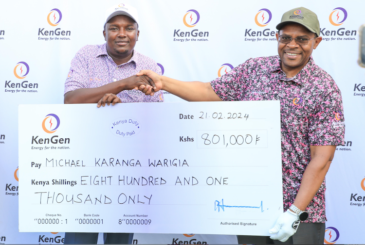 KenGen CEO Eng. Peter Njenga hands over the sponsorship cheque to amateur golfer Michael Karanga