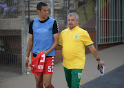 Highlands Park defender Bevan Fransman (L) walks onto the pitch at Makhulong Stadium in Temibisa during the Absa Premiership alongside Lamontville Golden Arrows coach Clinton Larsen on September 16 2018.