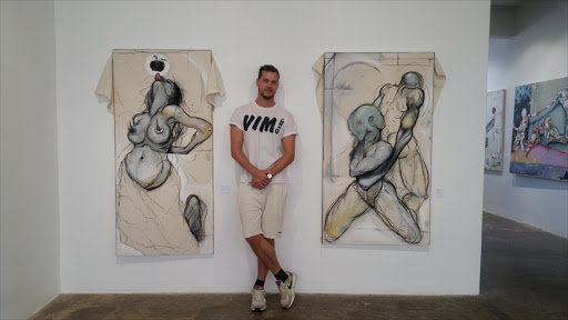 Artist Philipp Pieroth poses next to some of his artworks at The AGOG Gallery in Maboneng, Johannesburg.