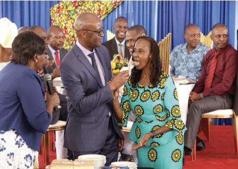 General Francis Ogolla feeding his wife Aileen Kathambi Ogolla a cake.