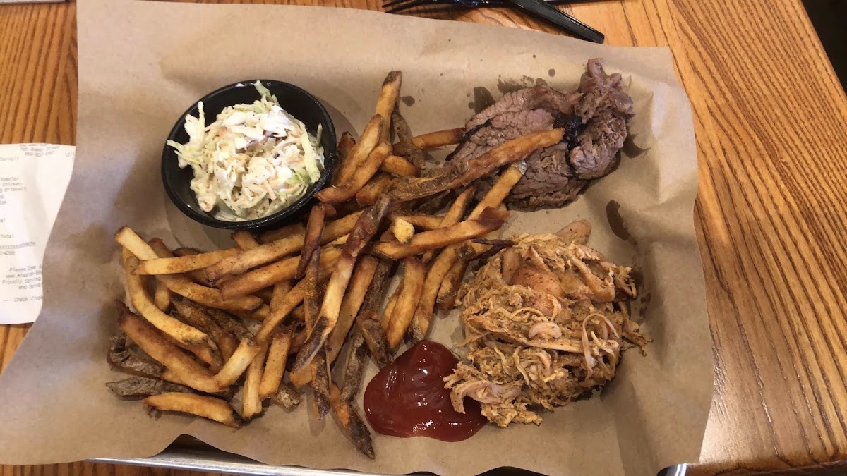 Gluten free French fries and coleslaw and meat sampler (2 piece with chicken and brisket). Some of the best meat and southern style sides I’ve ever had!