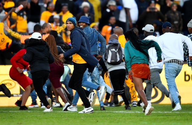Kaizer Chiefs fans storms the pitch during the MTN8, quarterfinal match against Stellenbosch FC at Danie Craven Stadium on August 28 in Stellenbosch.