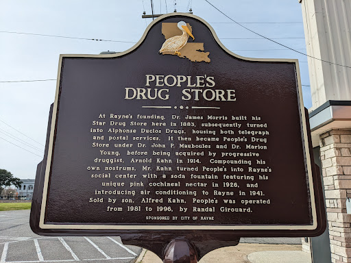 At Rayne's founding, Dr. James Morris built his Star Drug Store here in 1883, subsequently turned into Alphonse Duclos Drugs, housing both telegraph and postal services. It then became People's...