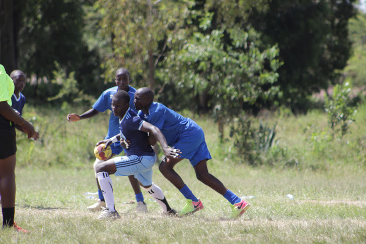 Manyatta (Blue) take on Mwangea (light blue shorts) at the boys handball games in the national finals in Machakos