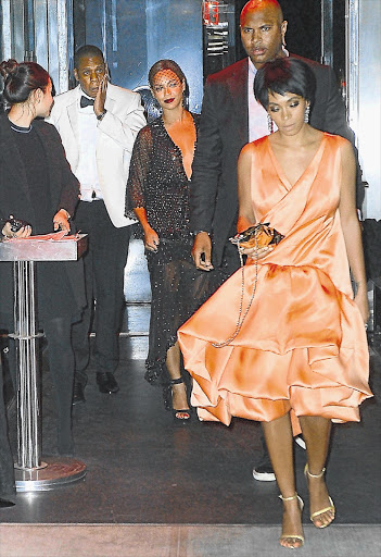 AFTER THE STORM: Solange Knowles, front, is clearly not pleased as she walks ahead of sister Beyonce and Jay-Z at the Met Gala after party.