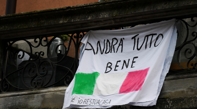 A banner with an Italian flag and reading "All will be well" is seen as the spread of coronavirus disease (COVID-19) continues, in Milan, Italy March 20, 2020.