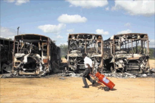 TORCHED: About 20 buses belonging to Buscor in Mpumalanga were burnt in the early hours of yesterday. Pic: ANDREW HLONGWANE. Circa April 2010. © Sowetan