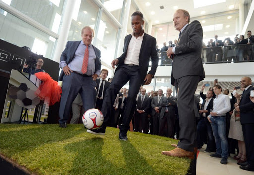 (L-R) FIFPro honorary president Gordon Taylor, soccer player Didier Drogba and secretary general of FIFPro Theo van Seggelen attends the opening of the new building of FIFPro, the worldwide representative organization for professional soccer players, in Hoofddorp, on May 13, 2013. AFP PHOTO / ANP PHOTO / MARCO DE SWART