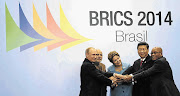 LENDING A HAND: Russian president Vladimir Putin, Indian prime minister Narendra Modi, Brazilian president Dilma Rousseff, Chinese president Xi Jinping and President Jacob Zuma pose for a group photo session during the sixth Brics summit in Fortaleza, Brazil